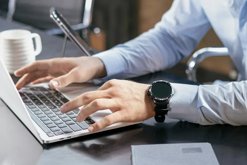 Hands typing on a laptop keyboard